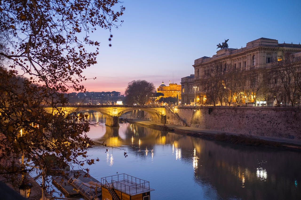 Evening scene of Ponte Umberto over the Tiber River in Rome, Italy, beautifully illuminated.